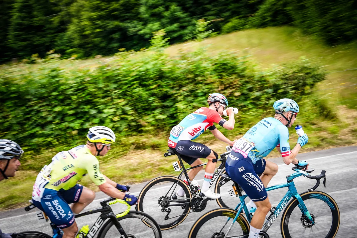 Tour de France riders drinking from bottles