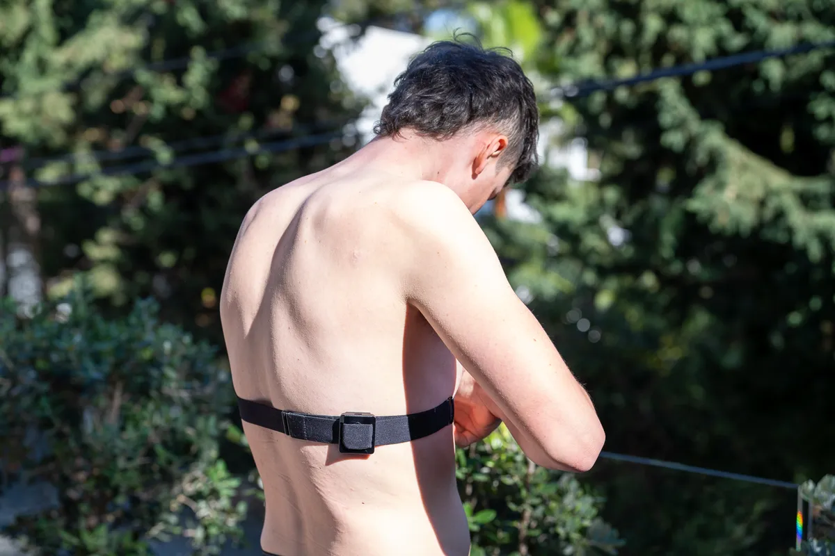 Man wearing Flowbio S1 sweat and hydration sensor on heart-rate monitor