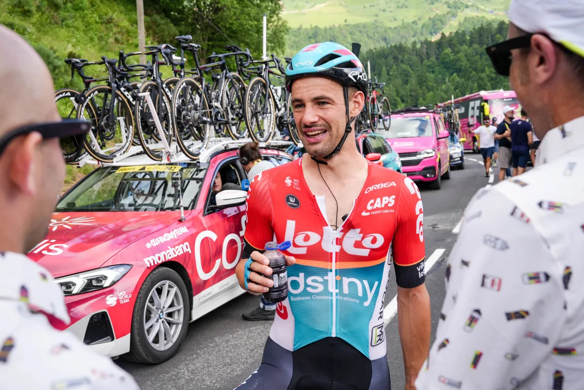 Victor Campanaerts holding a berry juice drink after a Tour de France stage
